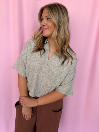 girl wearing a grey top 