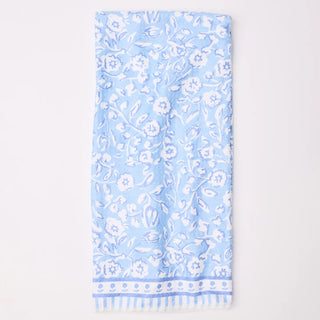 Light blue towel with white floral pattern on a light gray background