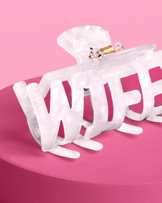 White hair claw clips on a pink background