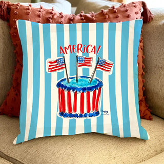 Decorative pillow with American flag design and 'AMERICA!' text on a striped background.