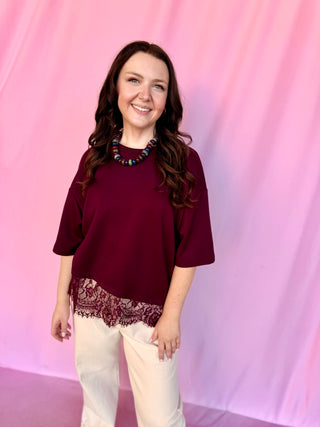girl wearing red top on a pink background 