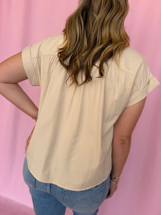 girl wearing a beige top