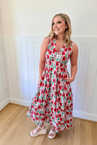 Woman wearing a floral dress and decorative headpiece indoors.