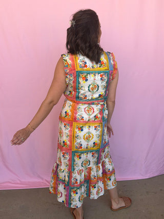 woman wearing a colorful dress on a pink background