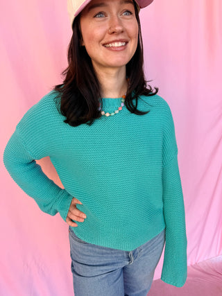 woman wearing a blue sweater 