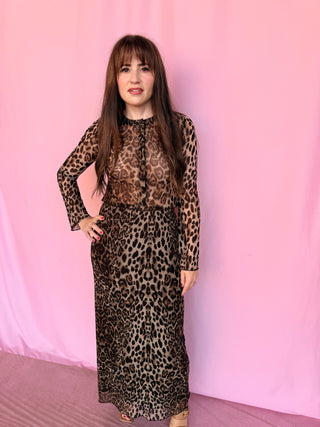 woman wearing a cheetah set on a pink background