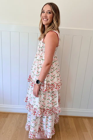 Woman wearing a floral dress with a white wall background