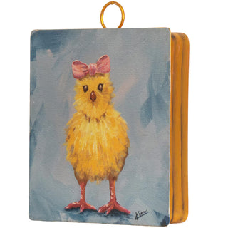 Small painting of a yellow chick with a pink bow on a blue background