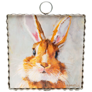 Framed artwork of a rabbit's face with a textured border
