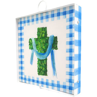 Decorative item with a green cross and blue scarf on a blue and white checkered background