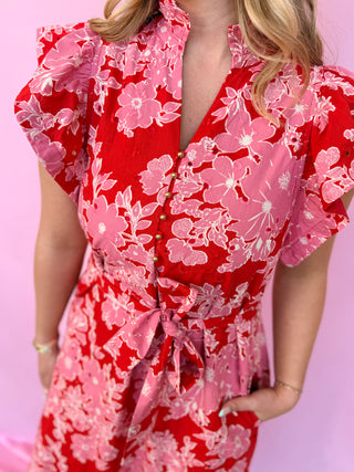Red floral dress with pink flowers on a pink background