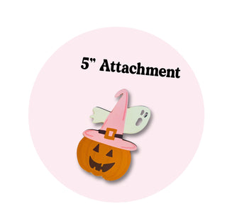 A circular graphic with a pale pink background and black text reading '5" Attachment' above a small Halloween illustration of a jack-o'-lantern in a pink witch hat with a pale green ghost behind it.