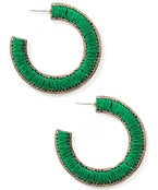 Green hoop earrings on a white background