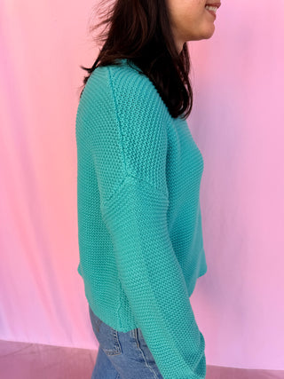 woman wearing a blue sweater 