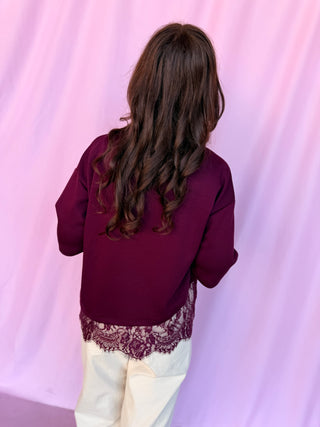 girl wearing red top on a pink background 