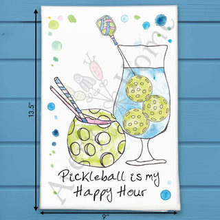 Tea towel with pickleball-themed design and text on a blue wooden background