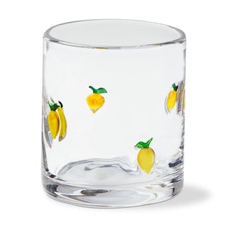 Clear glass tumbler with lemon designs on a white background