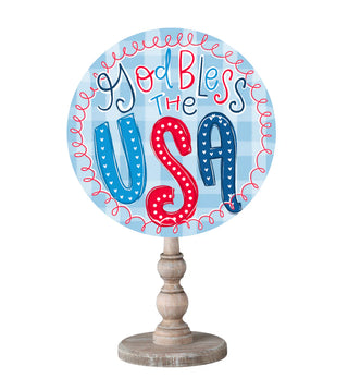 Decorative sign with 'God Bless the USA' text on a white background