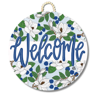 Round decorative sign with floral design and 'Welcome' text on a white background