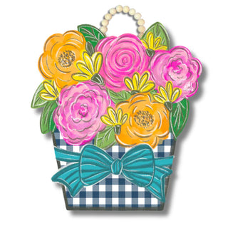 Decorative wall hanging with colorful flowers and a bow on a white background