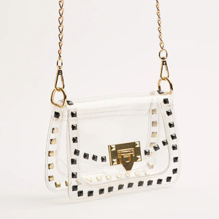 White handbag with gold accents and studded details on a white background