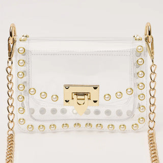 White handbag with gold chain strap and decorative studs on a white background