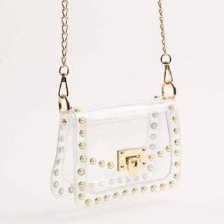 Clear handbag with gold studs and chain strap on a white background