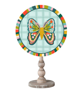 Decorative item with a colorful butterfly design on a circular board with a wooden stand.