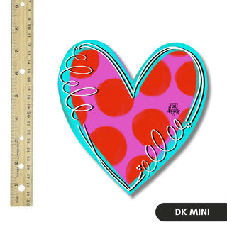 Heart-shaped decorative item with red polka dots and turquoise border next to a ruler for scale.