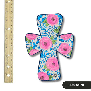 Decorative cross with floral patterns and blue background, next to a ruler for scale.