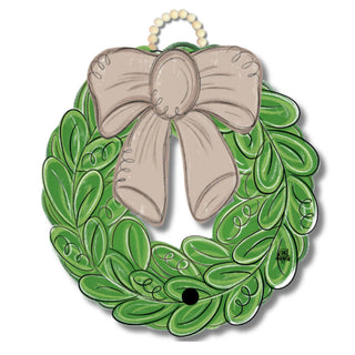 Decorative green wreath with a beige bow on a white background
