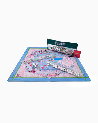 Mahjong game set with tiles and board on a white background