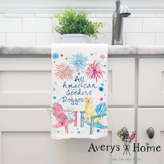 Decorative towel with 'All American Goodest Dogges' text and dog illustrations on a kitchen counter.