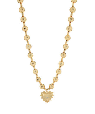 Gold beaded necklace with a heart-shaped pendant on a white background