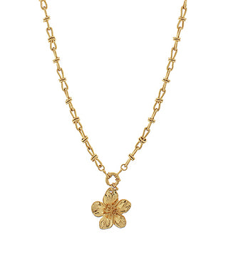 Gold necklace with a flower pendant on a white background
