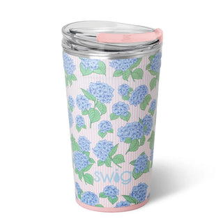 Tumbler with blue floral pattern and pink lid on a white background