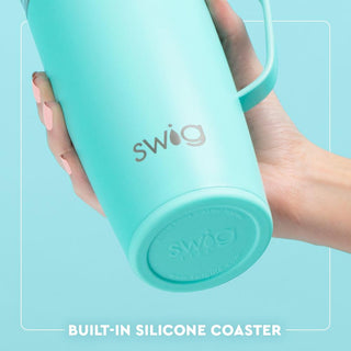 Turquoise Swig tumbler held by a hand with a light blue background