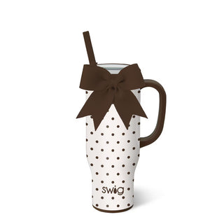 White polka dot mug with brown handle and bow, featuring the brand 'swig', on a white background.