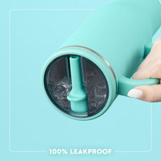 Teal tumbler with a straw and ice cubes on a light blue background, labeled '100% leakproof'.