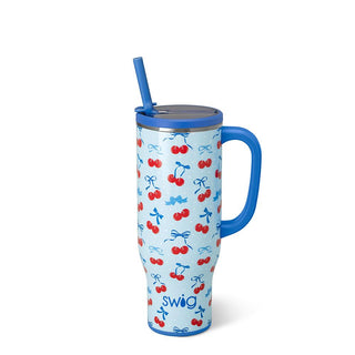 Blue mug with cherry and bow pattern on a white background