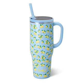 Blue mug with lemon pattern and straw on a white background