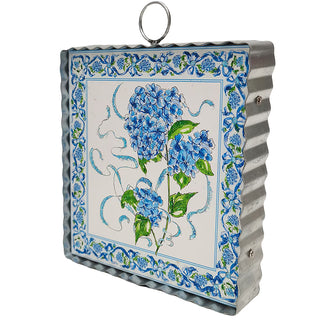 Decorative wall art with floral design and metal frame on a white background