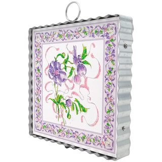 Decorative wall art with floral design and metal frame on a white background