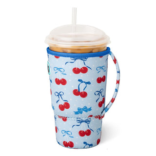 Tumbler with a blue sleeve featuring red cherries and blue bows on a white background
