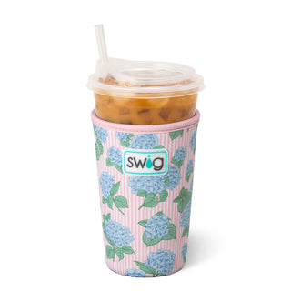 Pink floral-patterned cup with a drink and straw, featuring the Swig brand.