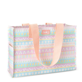 A pastel patterned tote bag with peach-colored handles and a small 'swig' logo patch on the front, set against a plain white background.