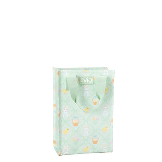A light mint green reusable shopping bag with a pattern of Easter-themed illustrations including bunnies, chicks, and baskets, featuring a white SWIG logo on the front.