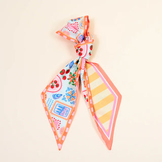 Colorful patterned hair bow on a beige background