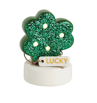 Decorative shamrock with glitter and 'Lucky' tag on a white background