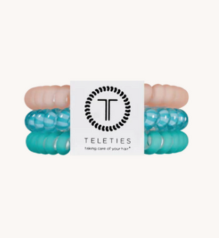 Turquoise hair ties with a brand logo on a white background